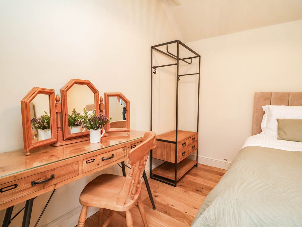 A bedroom with a desk and bed at Lyneal Cottage in Ellesmere