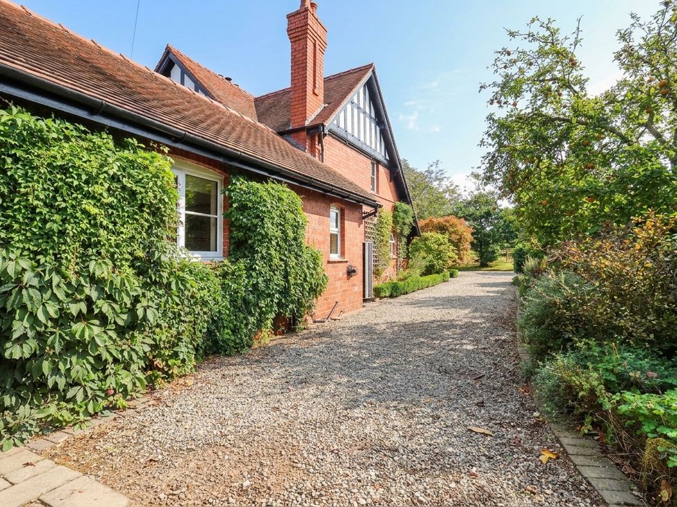 A house with a gravel pathway and greenery at Lyneal Cottage Ellesmere