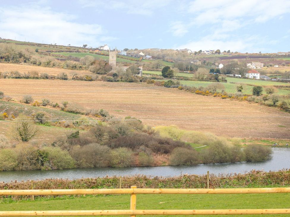 A view of fields and a river with trees at Helford in Treverva near Constantine