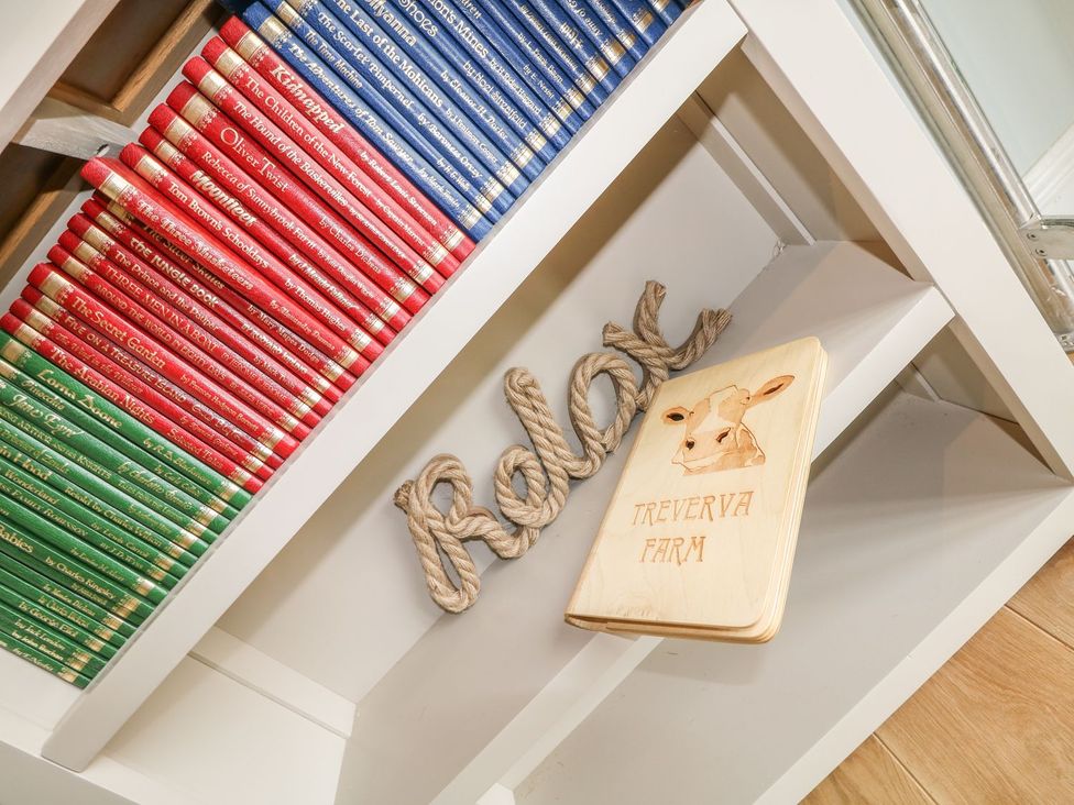 A shelf with books and a wooden sign at Helford in Treverva near Constantine