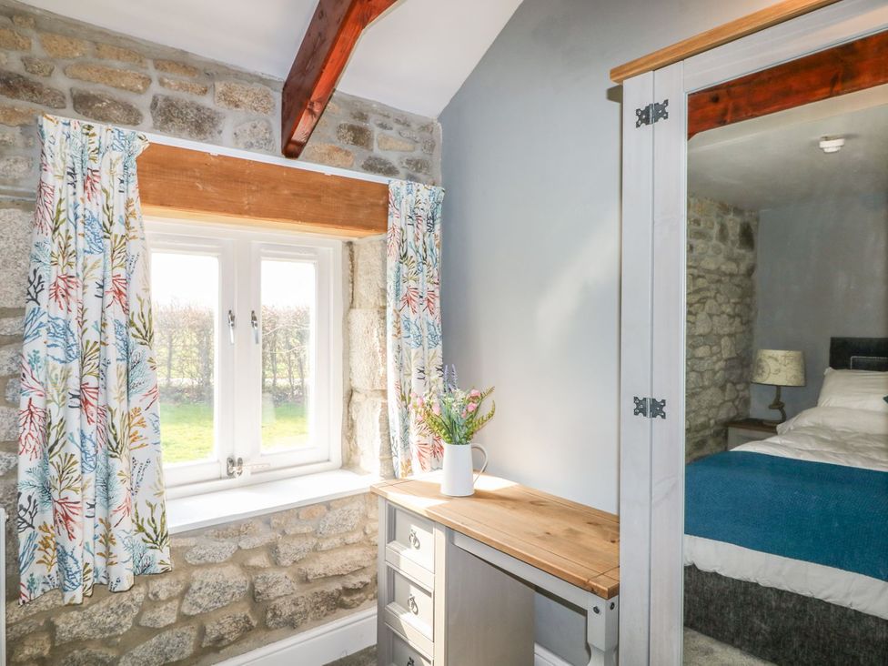 A bedroom with a desk and window at Helford in Treverva near Constantine