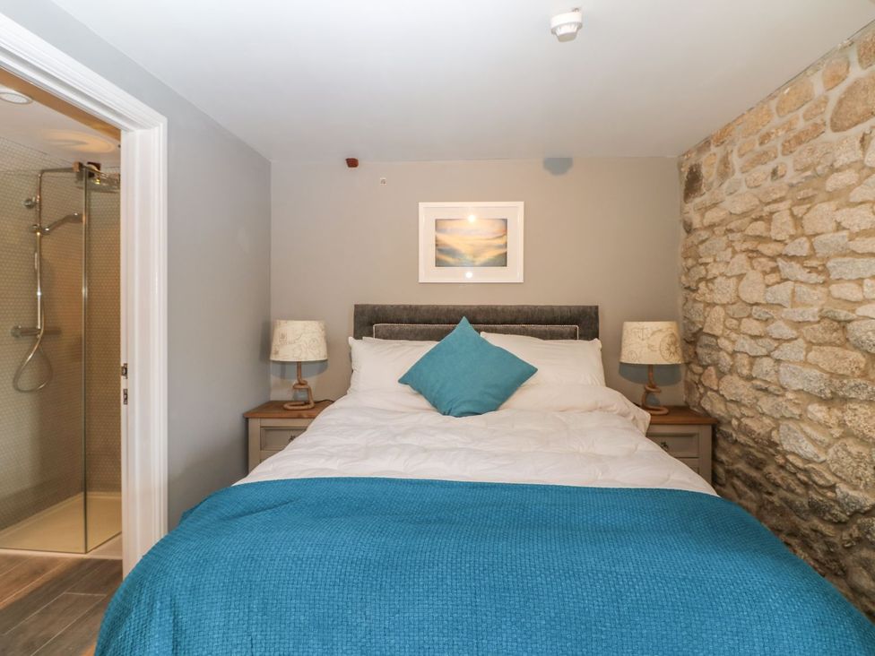 A bedroom with a bed and a shower at Helford in Treverva near Constantine