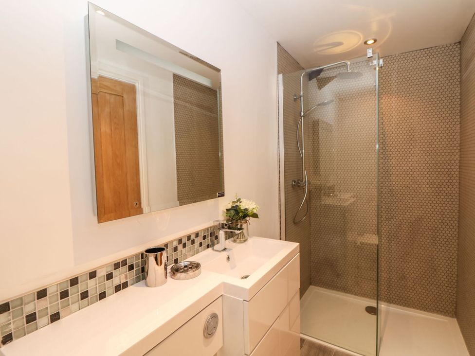 A bathroom with a shower and sink at Helford in Treverva near Constantine