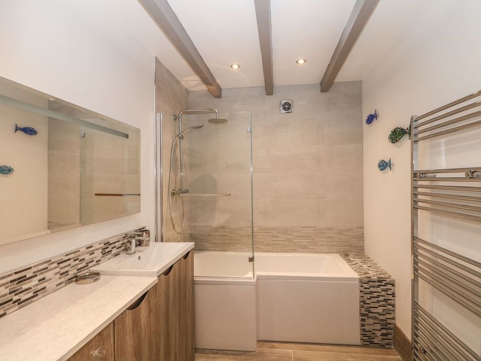A bathroom with a shower and bathtub at Helford in Treverva near Constantine