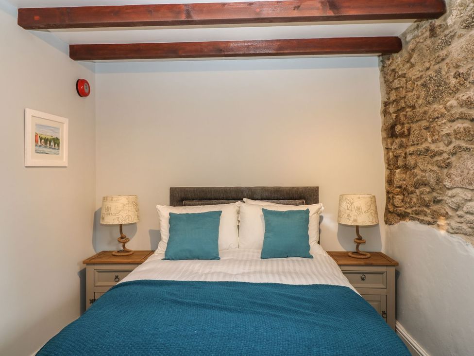 A bedroom with a bed and nightstand at Helford, Treverva near Constantine
