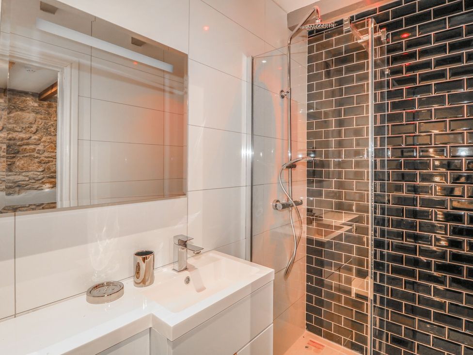 A bathroom with a sink and shower at Helford in Treverva near Constantine