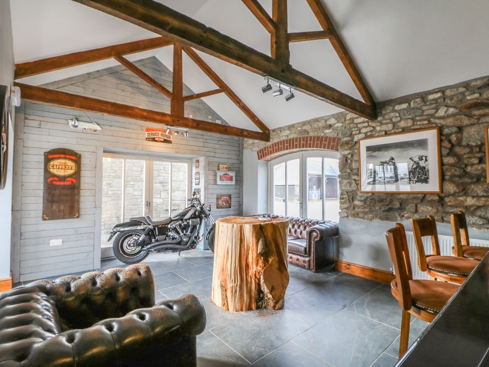A snug with a motorcycle and wood table at Helford in Treverva near Constantine