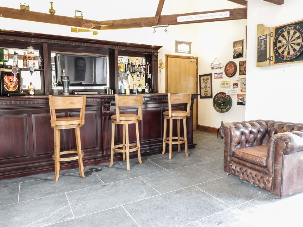 A bar with stools and a dartboard at Helford in Treverva near Constantine