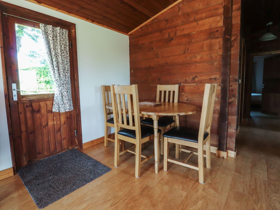 A dining room with a table and chairs at Chestnut Lodge in Pilling near Stake Pool