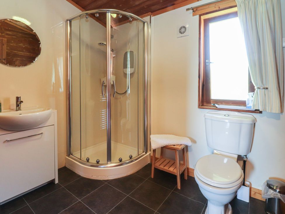 A bathroom with a shower and sink at Chestnut Lodge Pilling near Stake Pool