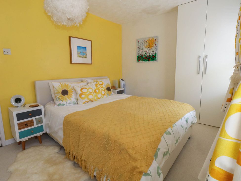 A bedroom with a bed and artwork at Driftmark in Weymouth