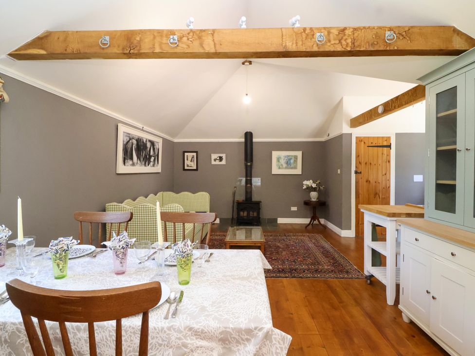 A dining room with a table set for dinner at The Old Dairy Corsley near Warminster