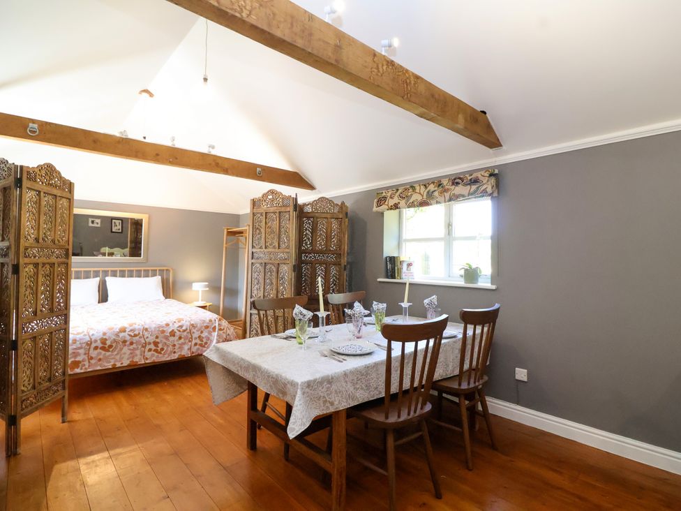 A dining area with a table and chairs in The Old Dairy Corsley near Warminster