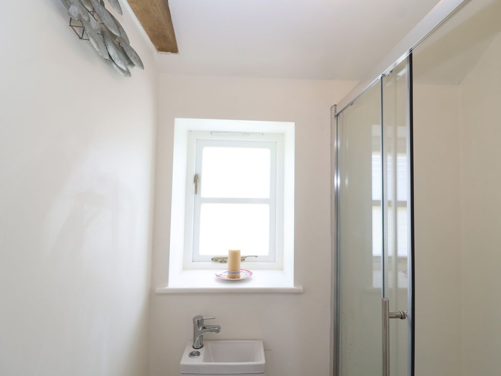 A bathroom with a shower and a sink at The Old Dairy Corsley near Warminster