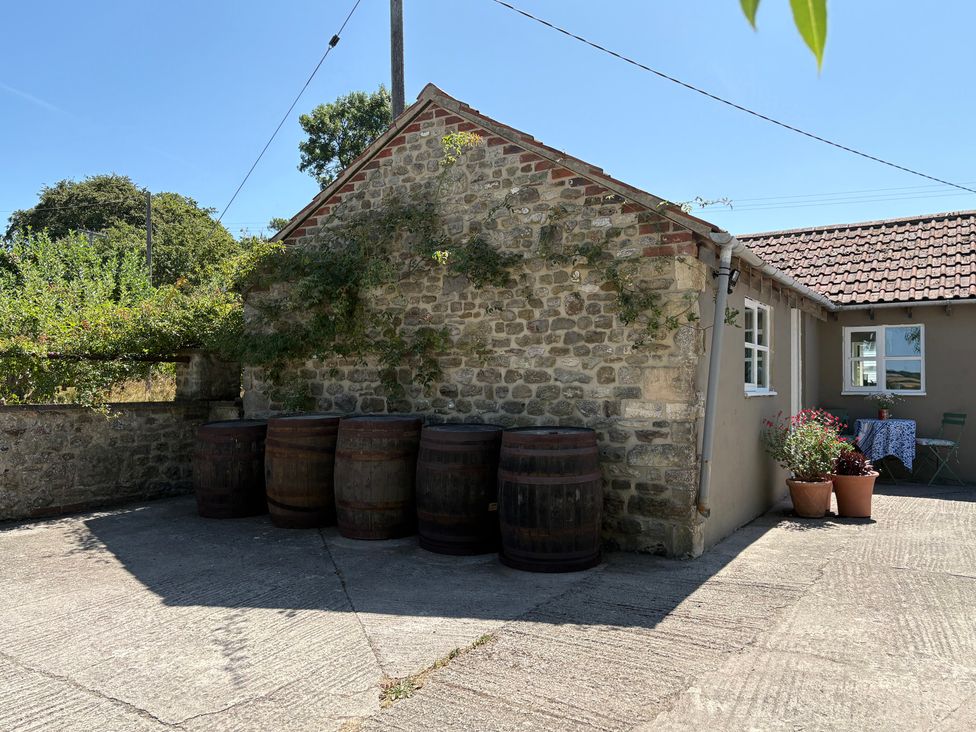 An outdoor area with barrels and a table at The Old Dairy Corsley near Warminster