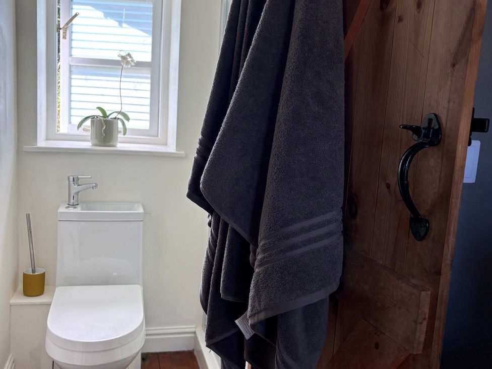 A bathroom with a toilet and a towel hanging at The Old Dairy in Corsley near Warminster