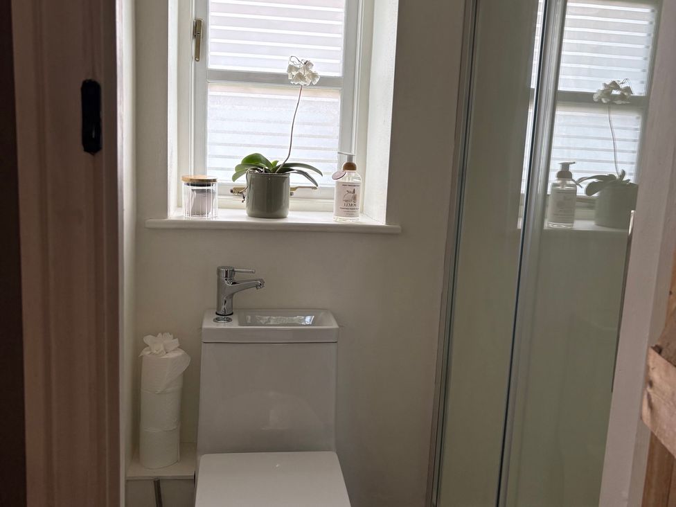 A bathroom with a toilet and sink at The Old Dairy Corsley near Warminster