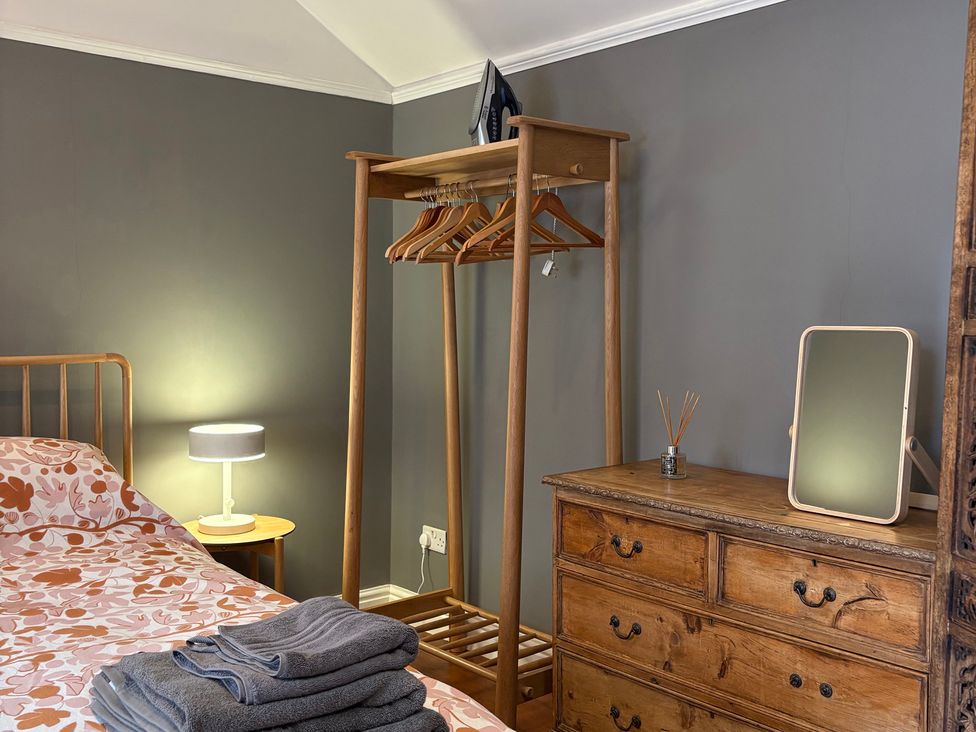 A bedroom with a bed and dresser at The Old Dairy Corsley near Warminster
