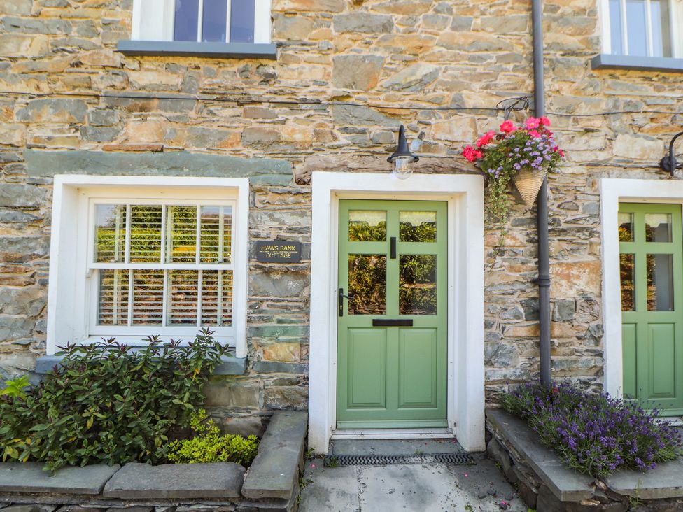 A front door with a stone wall at Haws Bank Cottage in Coniston