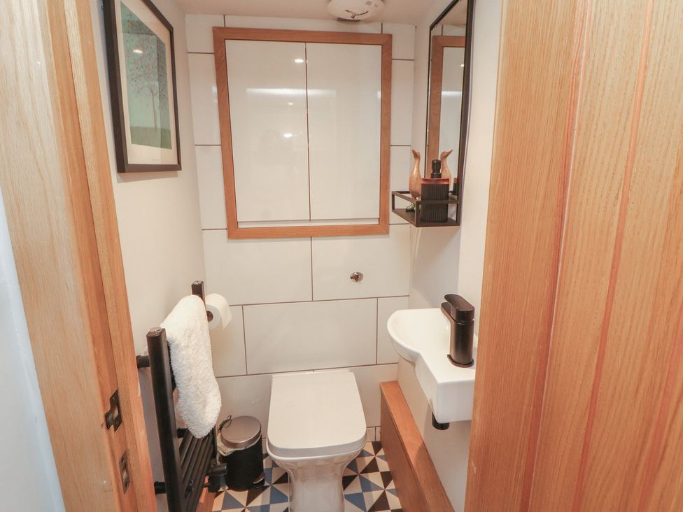 A bathroom with a toilet and sink at Haws Bank Cottage in Coniston