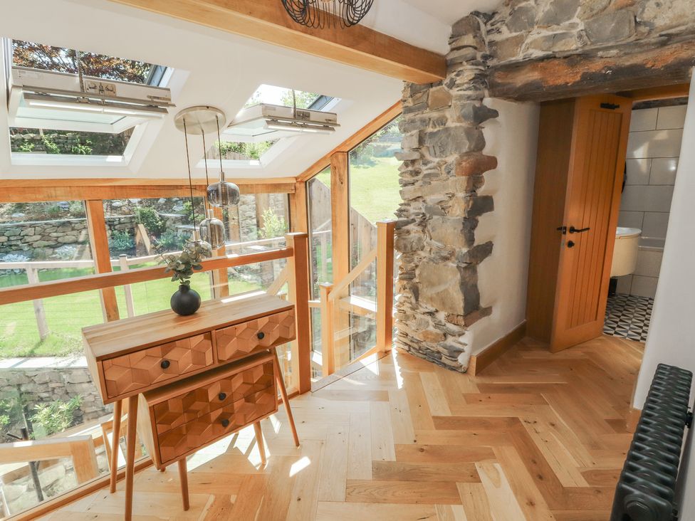 A hallway with a wooden dresser and skylights at Haws Bank Cottage in Coniston