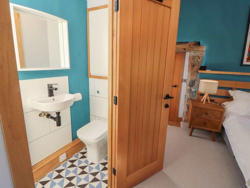A bathroom with a sink and toilet at Haws Bank Cottage in Coniston