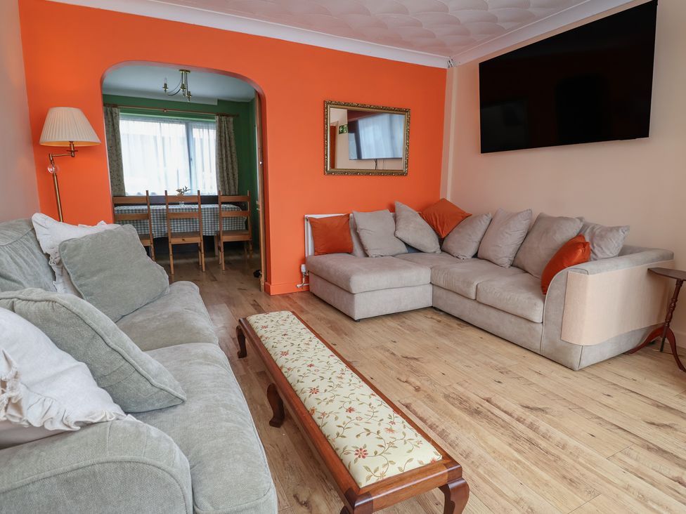A living room with a sofa and coffee table at Hafan Deg in Holywell