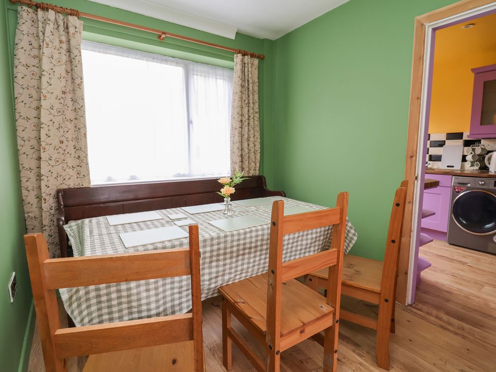 A dining room with a table and chairs at Hafan Deg in Holywell