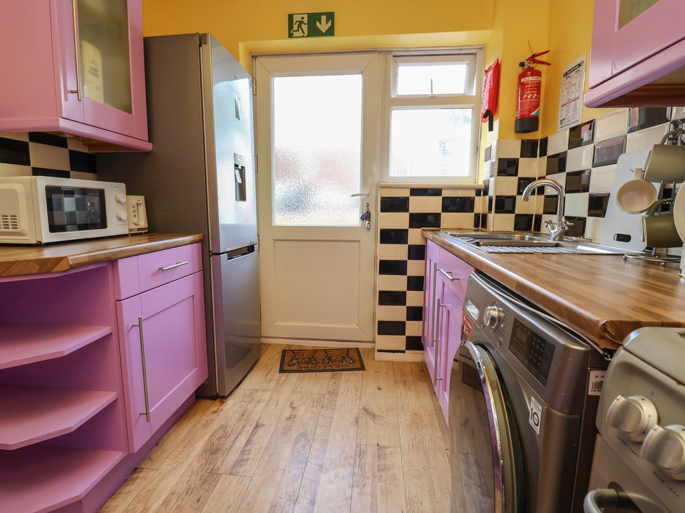 A kitchen with a refrigerator and microwave at Hafan Deg in Holywell