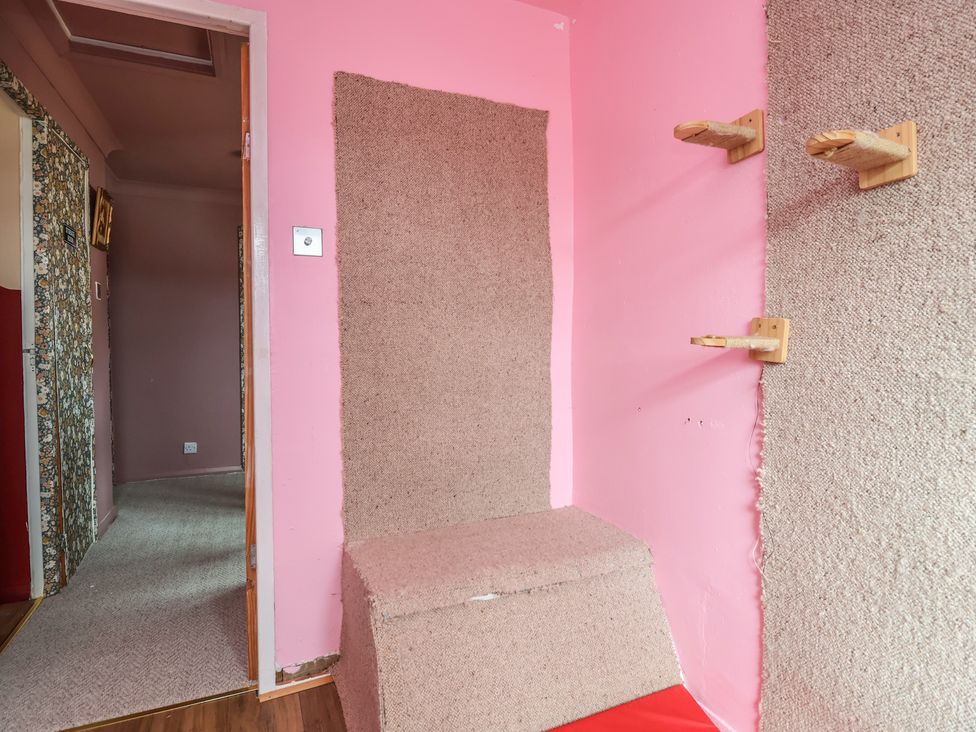 A room with a door and carpeted floor at Hafan Deg in Holywell