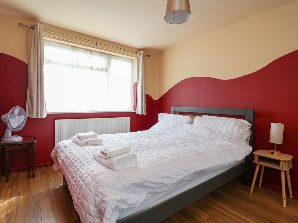A bedroom with a bed and bedside table at Hafan Deg in Holywell