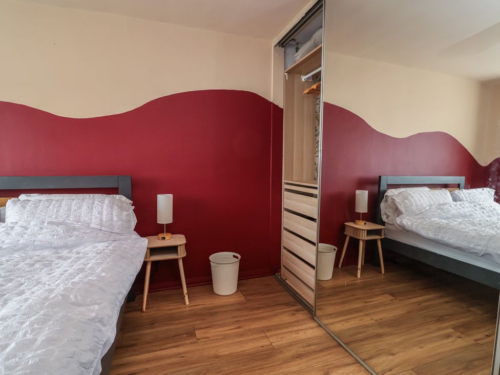 A bedroom with a bed and a nightstand at Hafan Deg in Holywell