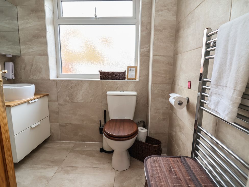 A bathroom with a toilet and sink at Hafan Deg in Holywell