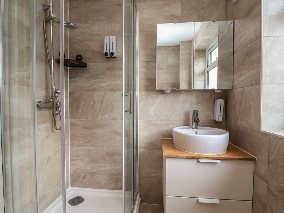 A bathroom with a shower and sink at Hafan Deg in Holywell