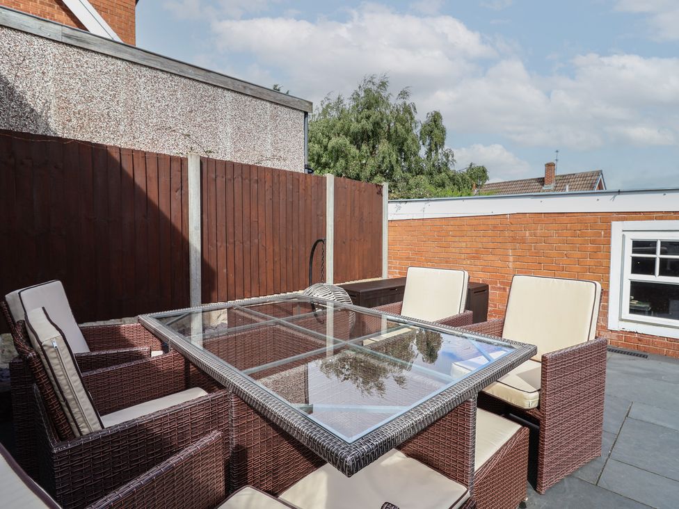 A patio with a table and chairs at Hafan Deg in Holywell