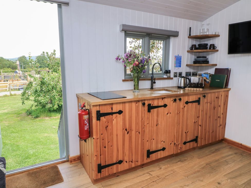 A kitchen with a wooden counter and sink at Damsons Williton