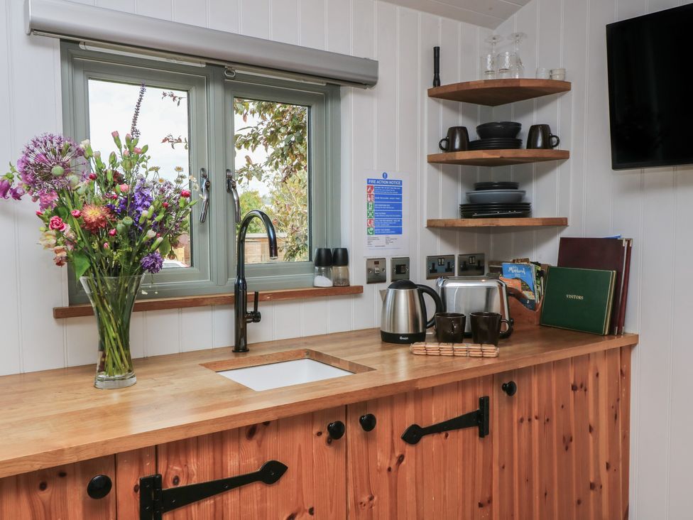 A kitchen with a sink and kettle at Damsons in Williton