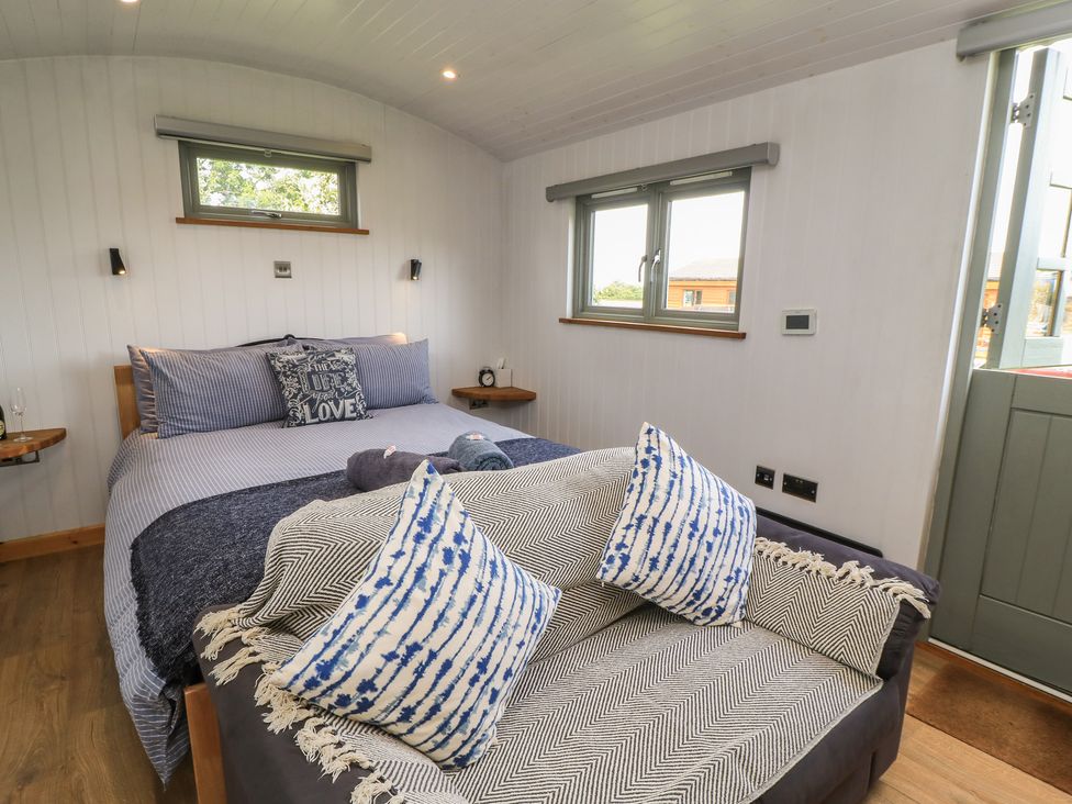 A bedroom with a bed and couch at Damsons in Williton