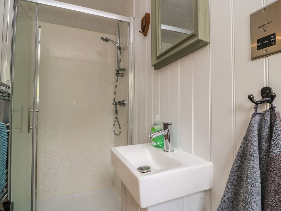 A bathroom with a shower and sink at Damsons in Williton