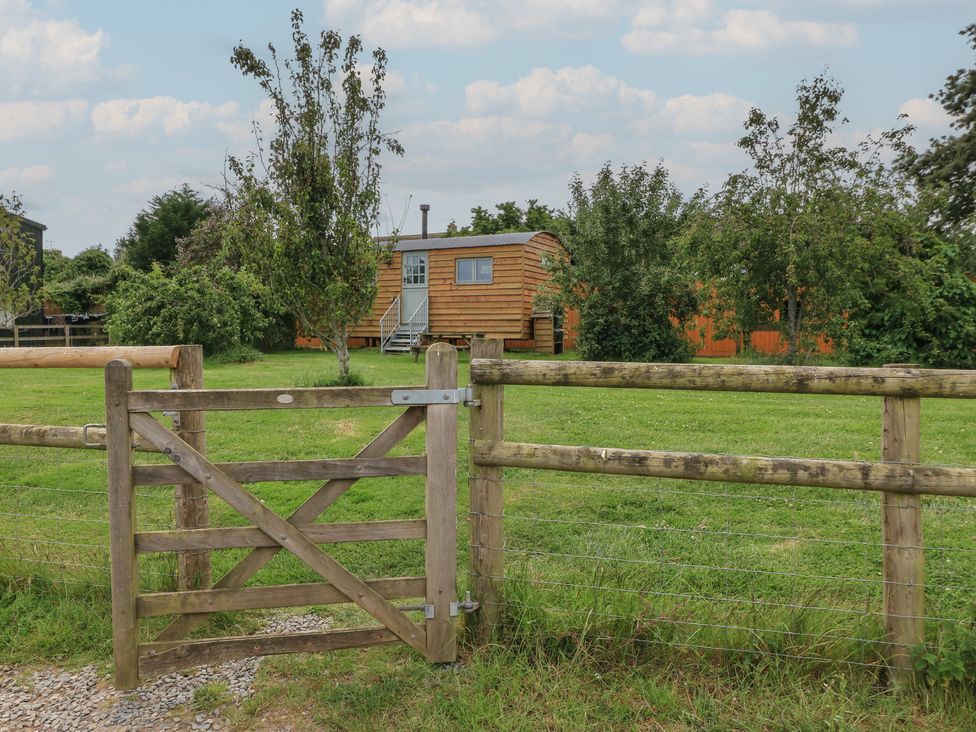 An outdoor area with a wooden gate and a hut at Damsons in Williton