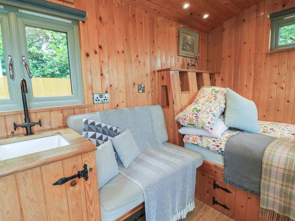 A room with a sofa and a bed at Pippins Taunton