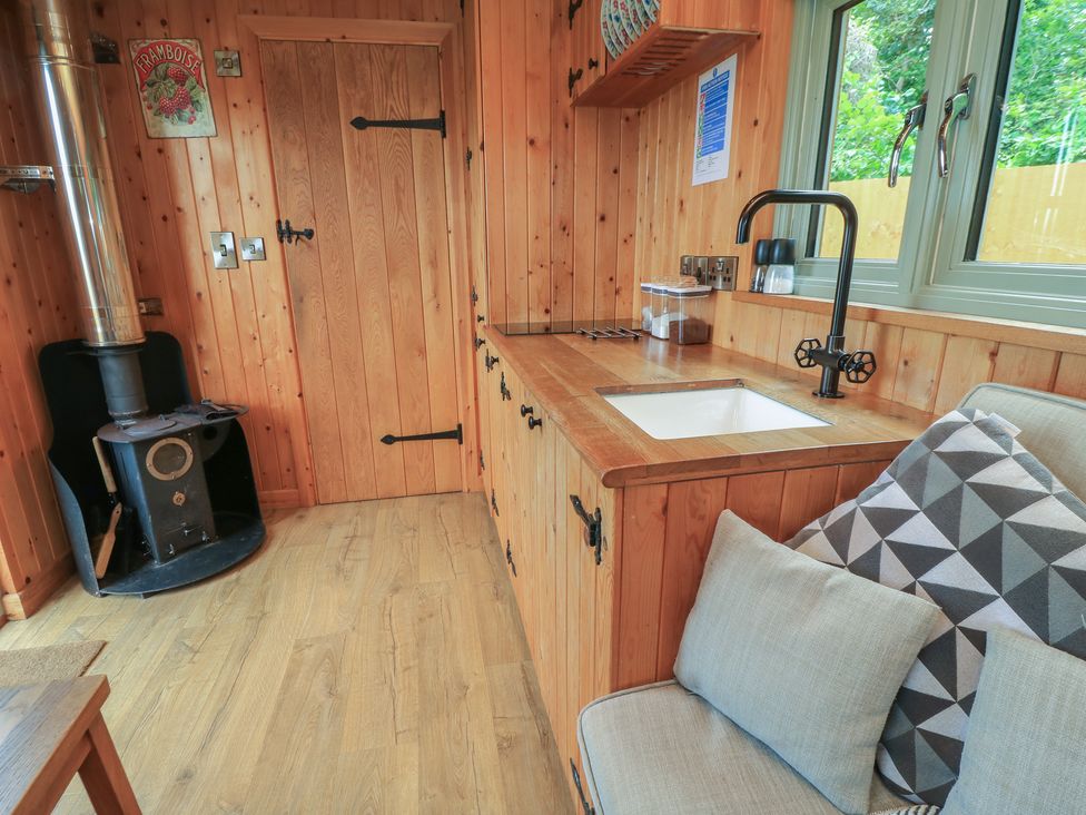 A kitchen with sink and stove at Pippins in Taunton