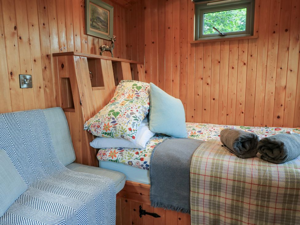 A bedroom with a bed and seating area at Pippins in Taunton