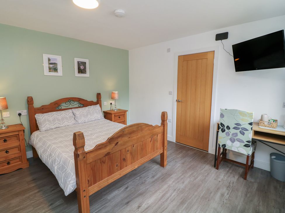 A bedroom with a bed and side tables at Kirkstead in Billinghay, Lincolnshire