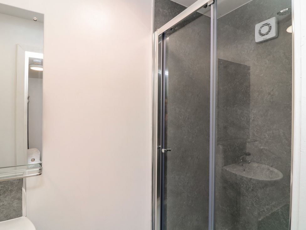 A bathroom with a shower and sink at Kirkstead in Billinghay, Lincolnshire