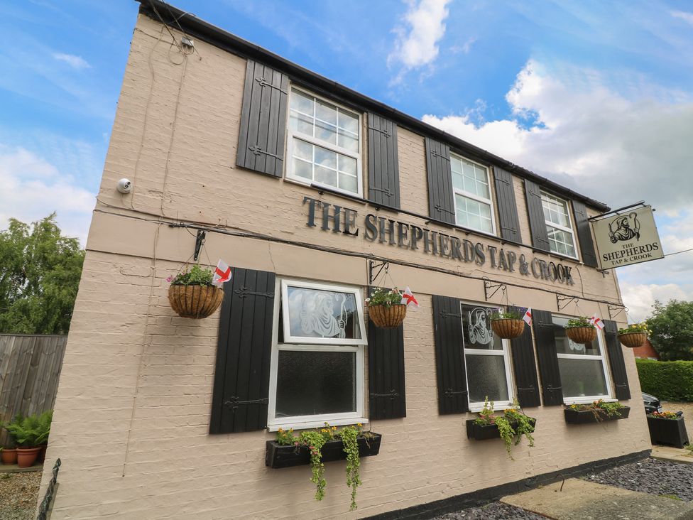 A pub exterior with windows and flower pots at The Shepherds Tap & Crook in Lincolnshire