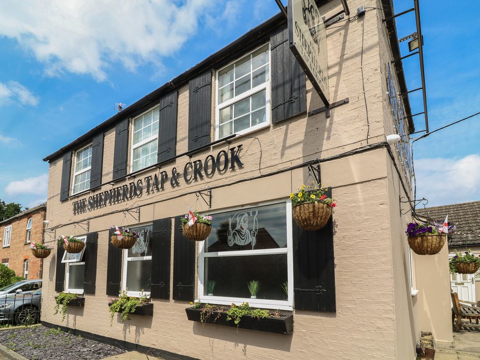 An exterior view of a pub with flower baskets at The Shepherds Tap & Crook in Billinghay, Lincolnshire