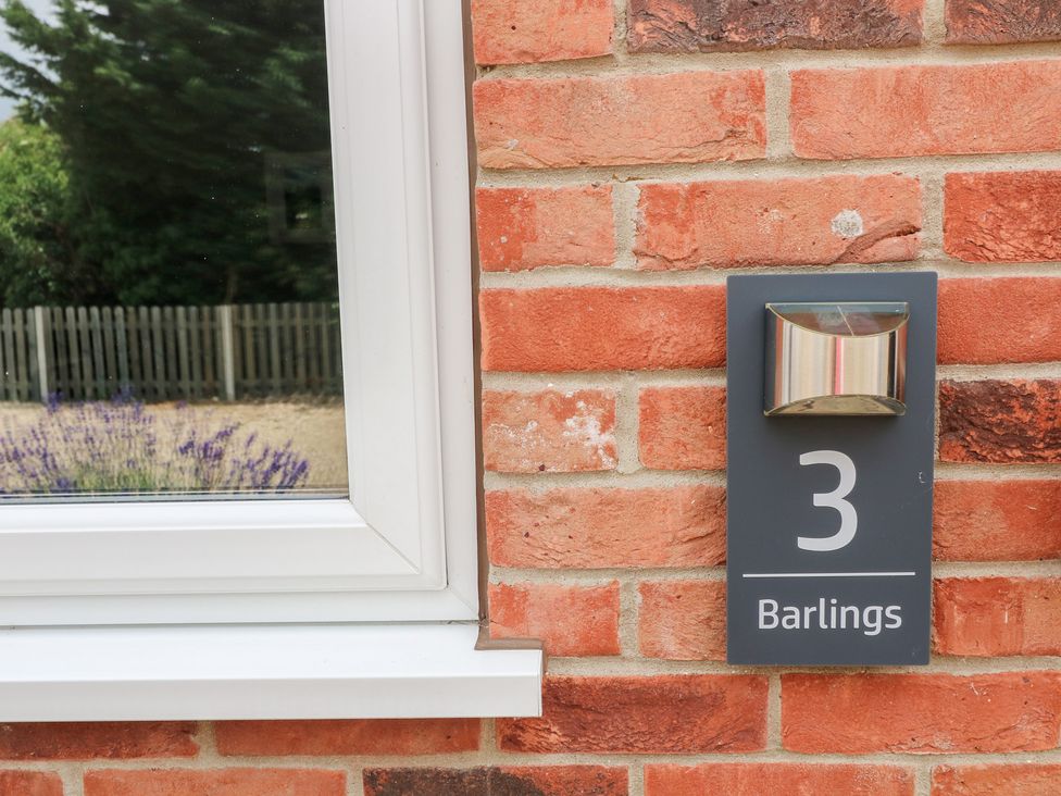 House number sign with number 3 on a brick wall at Barlings in Billinghay, Lincolnshire
