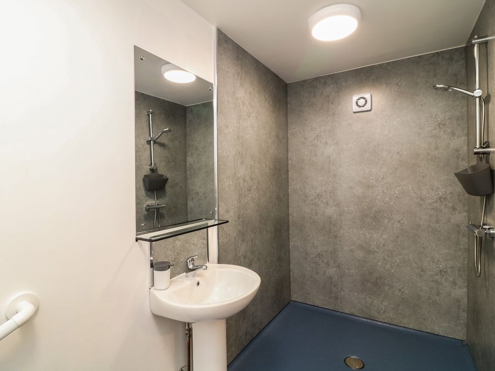 A bathroom with a sink and shower fixtures at Tupholme in Billinghay, Lincolnshire