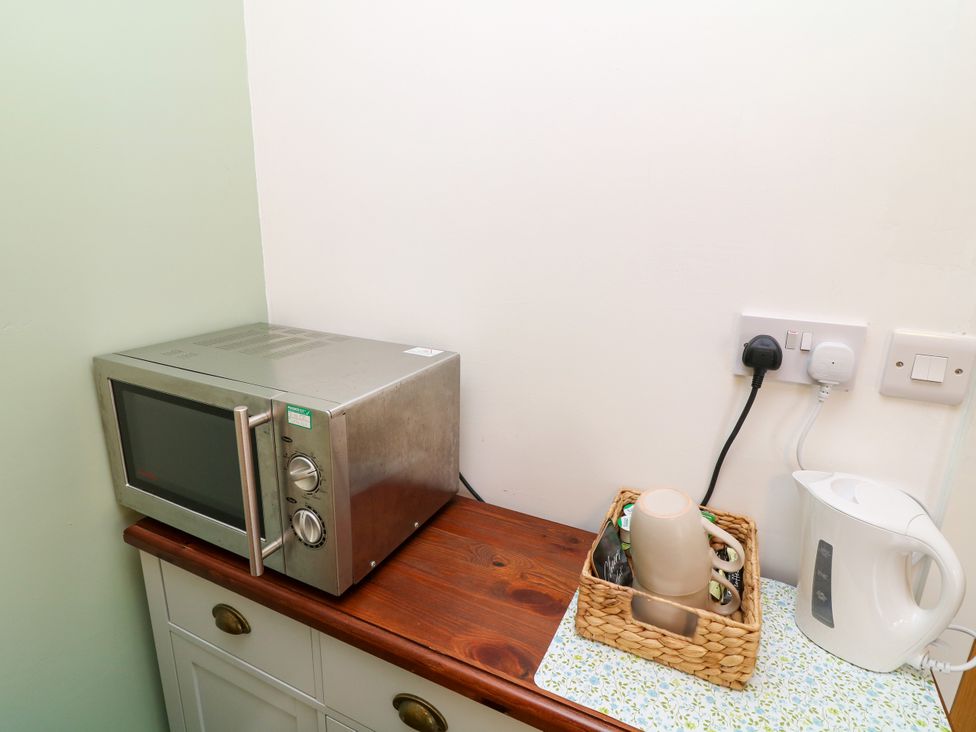 A kitchen with a microwave and kettle at Walcott Lodges - Tupholme in Billinghay, Lincolnshire